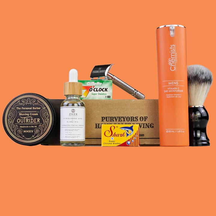 The Shaving Club Box for October/November 2025 on orange background featuring shaving cream, facial serum, moisturiser, safety razor and shaving brush