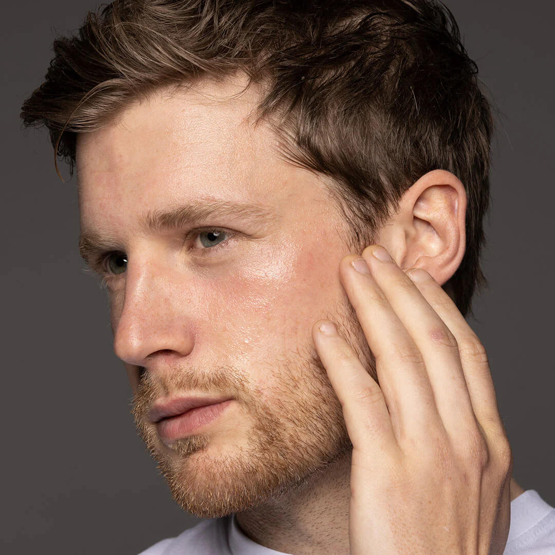 Man with beard touching face after using Face 4ward clarifying toner