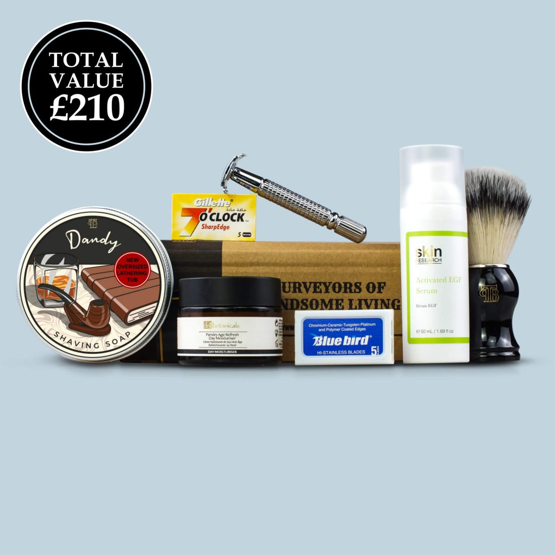 The complete shaving kit with july/aug '23 contents featuring dandy shaving soap, dr botanical men's moisturiser, men's EGF serum, our signature safety razor and cruelty-free shaving brush on a light blue background